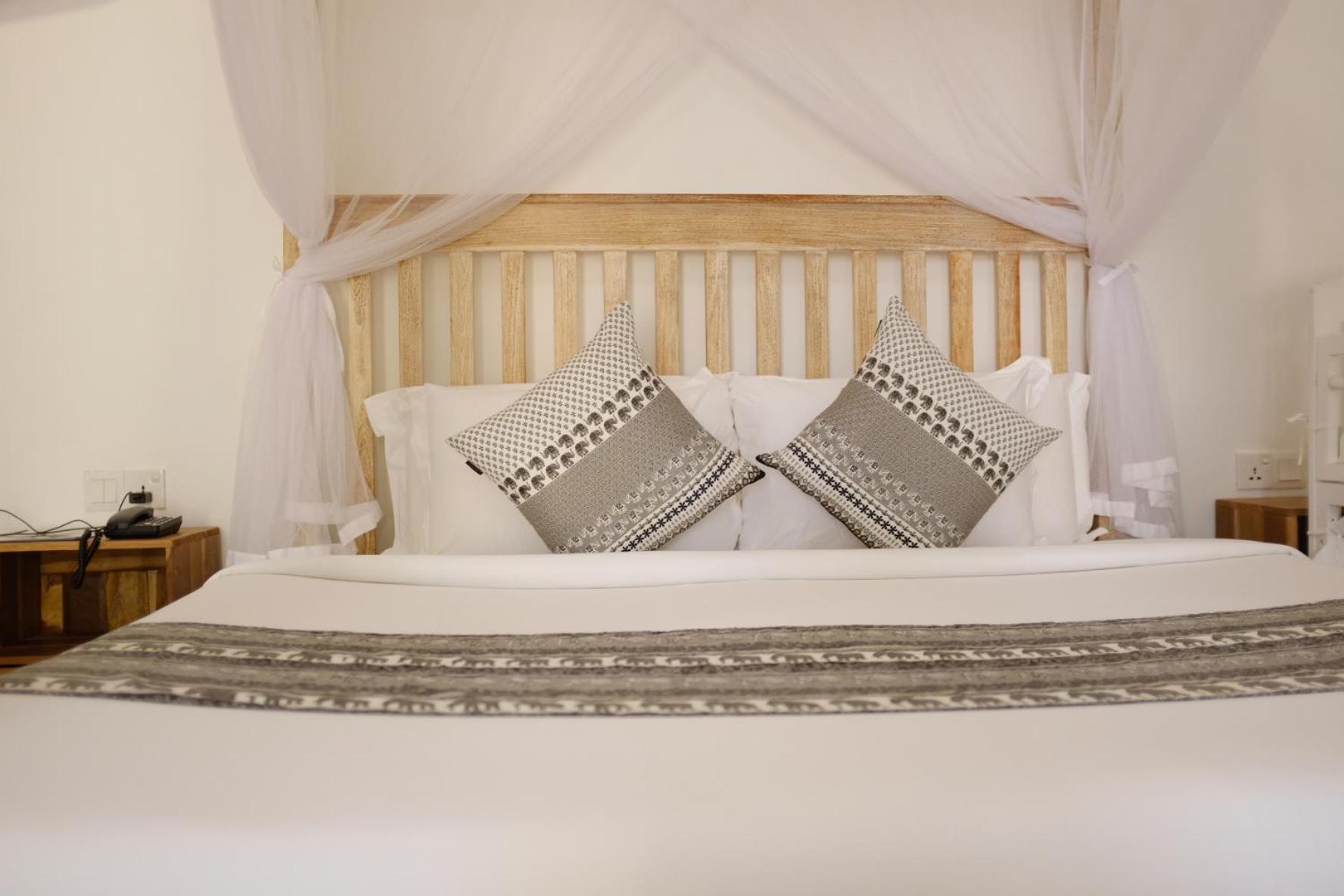 Nivadoo Resort סיגירייה חדר תמונה A bed with a mosquito net